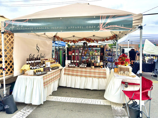 The Silk and Soul market booth full of handmade concrete and amber candles