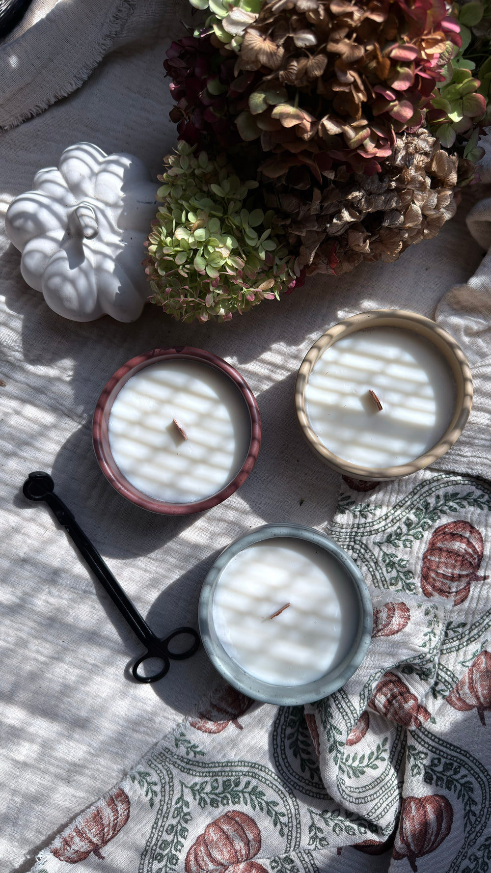 Three hand-poured Silk and Soul soy candles in handmade concrete vessels