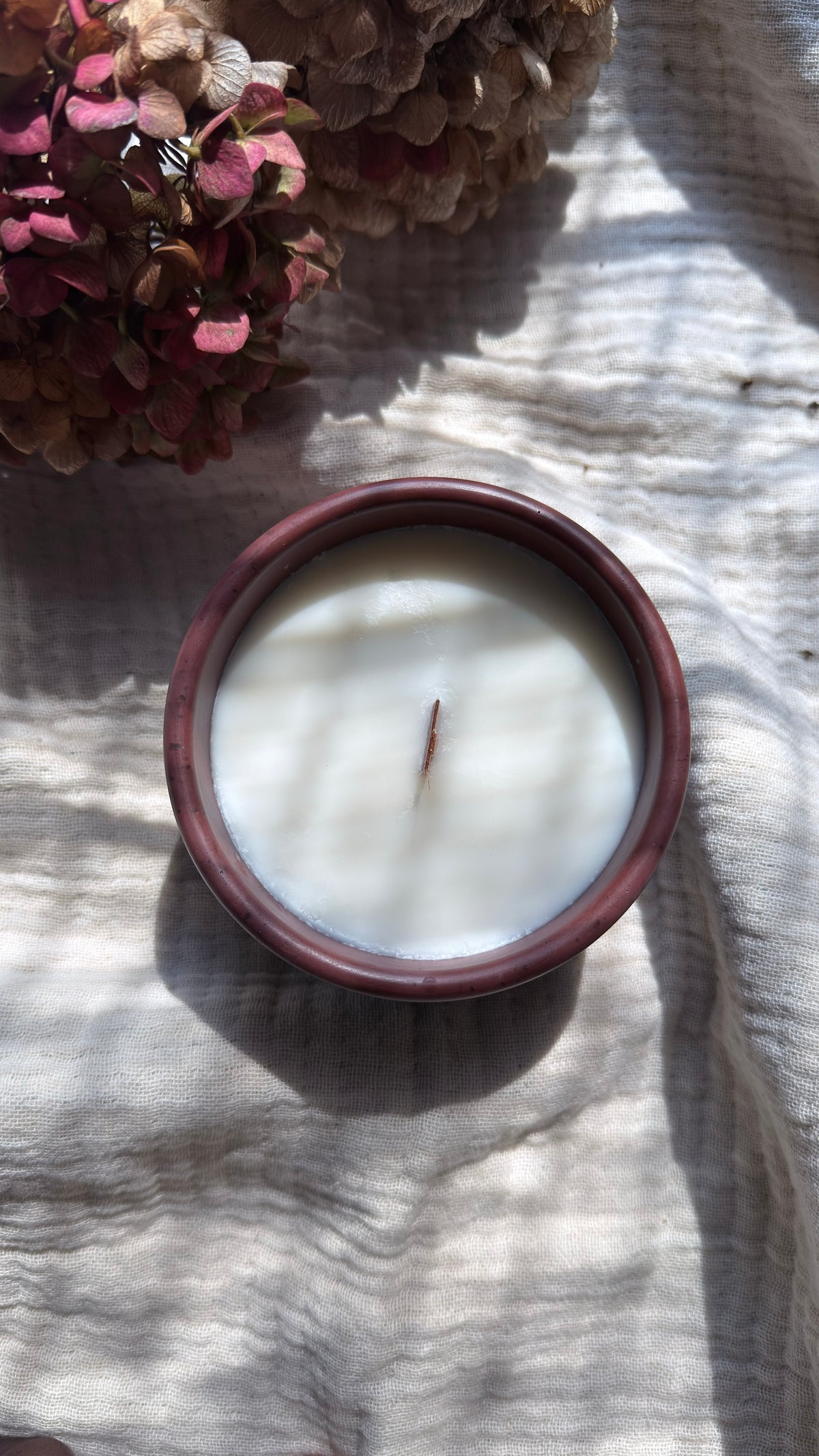 Grapefruit and vetiver soy candle with wooden wick in wine concrete vessel